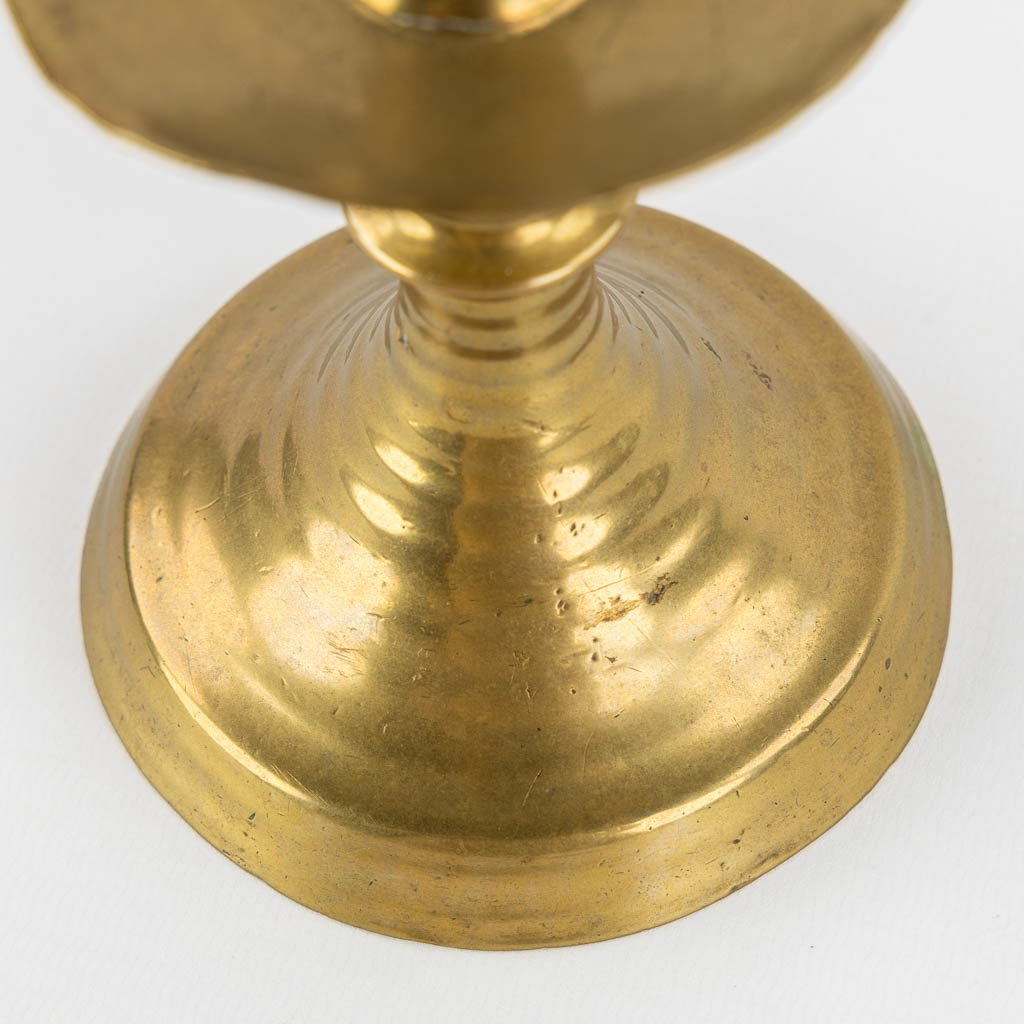 A brass disk candlestick, so-called 