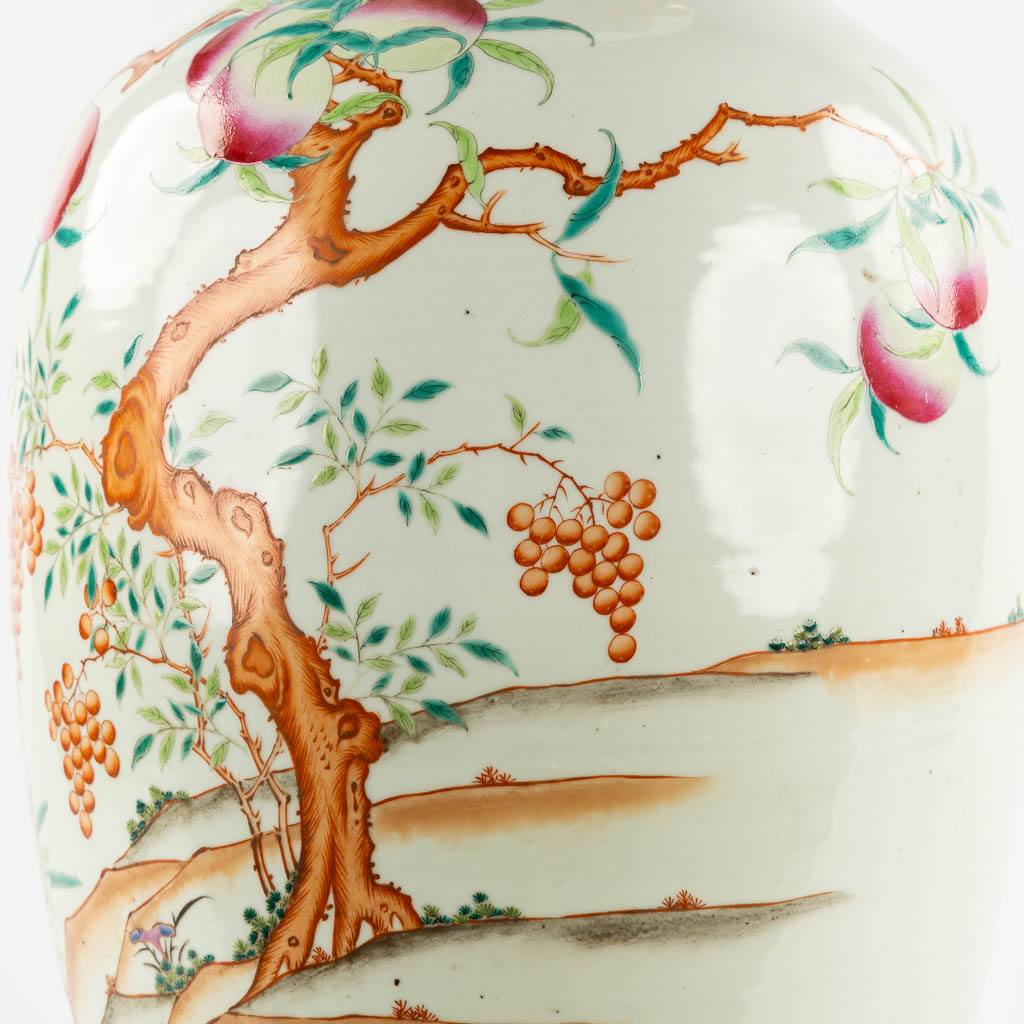 A large Chinese Famille Rose vase with a peach decor and elephant handles. 19th C. (H:70 x D:34 cm)