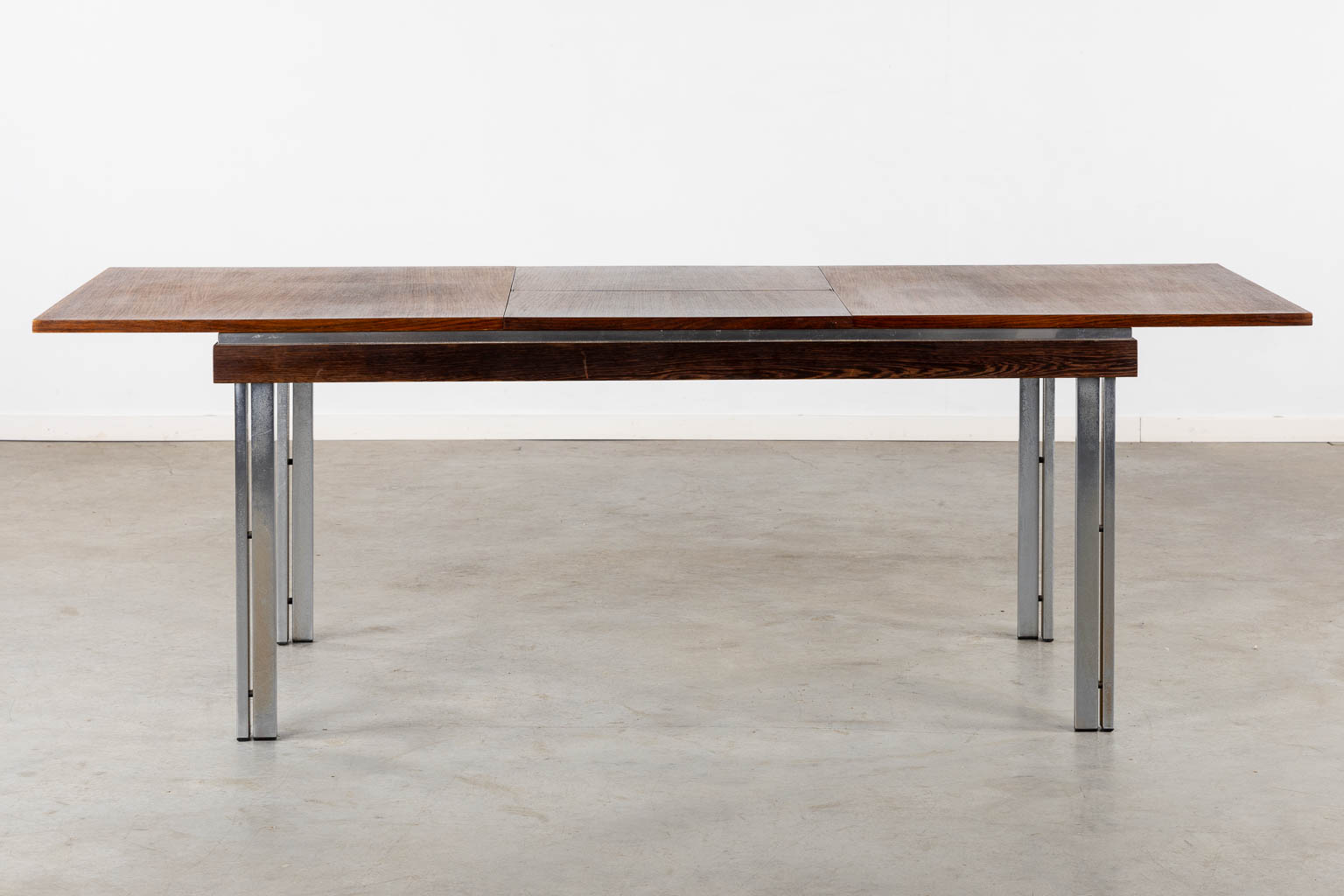 A mid-century table, veneer and chomed metal. By Roger De Winter. (L:84 x W:161 x H:74 cm)