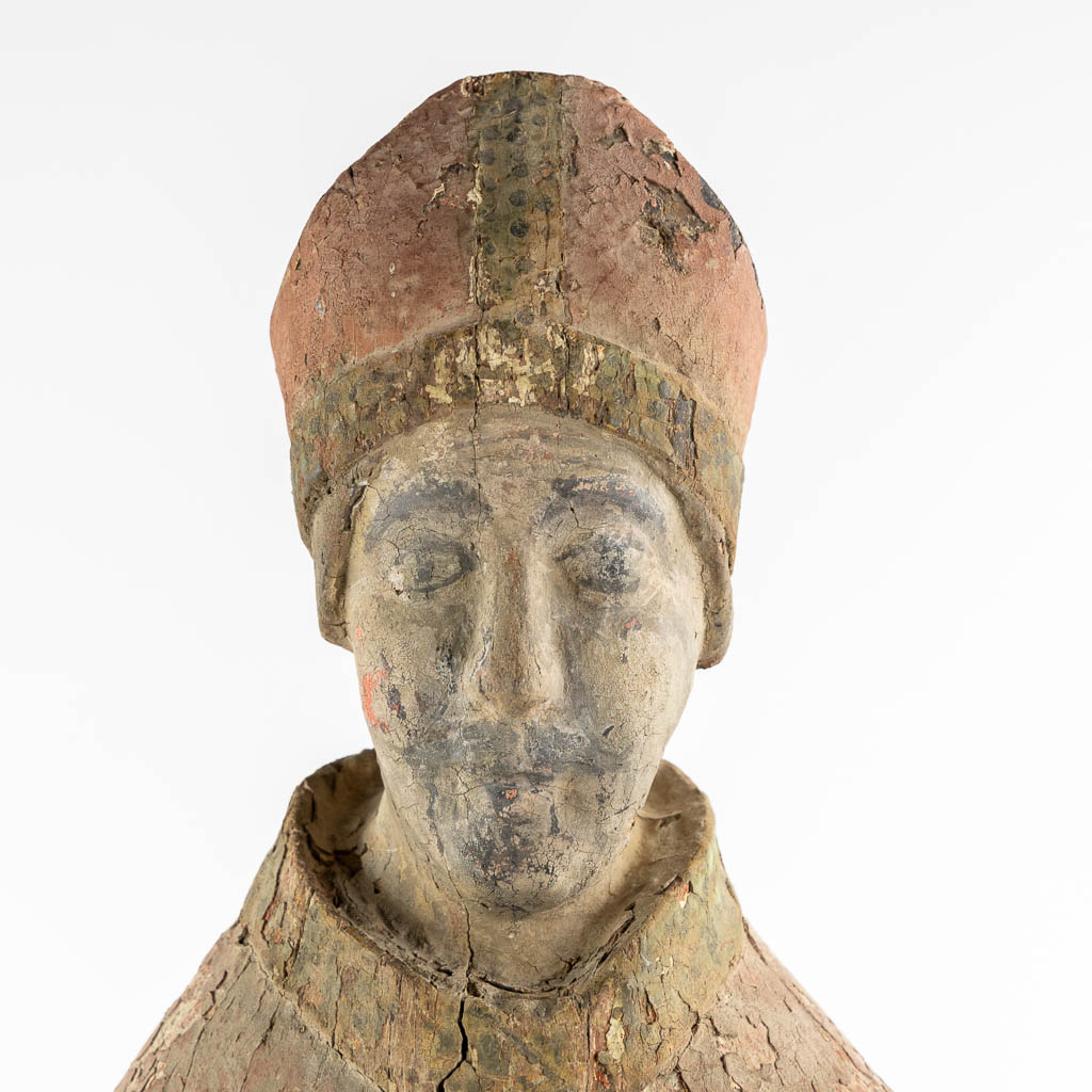 An antique wood-sculptured figurine of a Bishop, Roman, mid-13th/early 14th C. (L:23 x W:27 x H:88 cm)