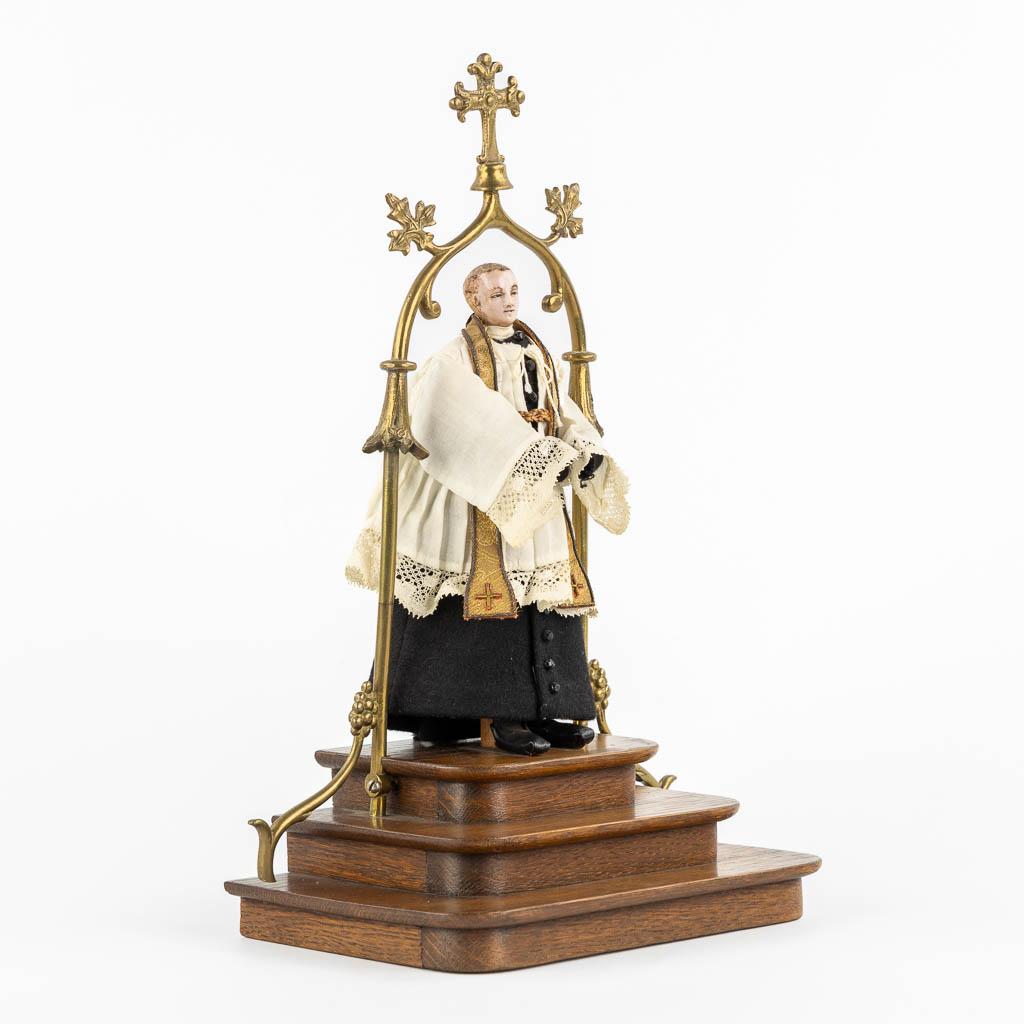 A shrine with a wax figurine of a saint, circa 1920. Gothic Revival. (L:14 x W:20 x H:33 cm)