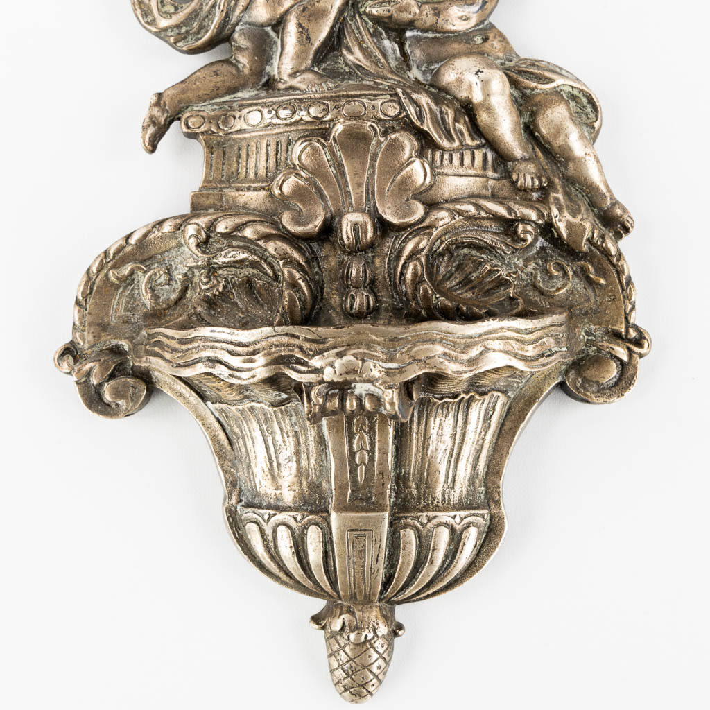 A holy water font in Baroque style, Angel figurines and a crucifix. Silver-plated bronze. 19th C.