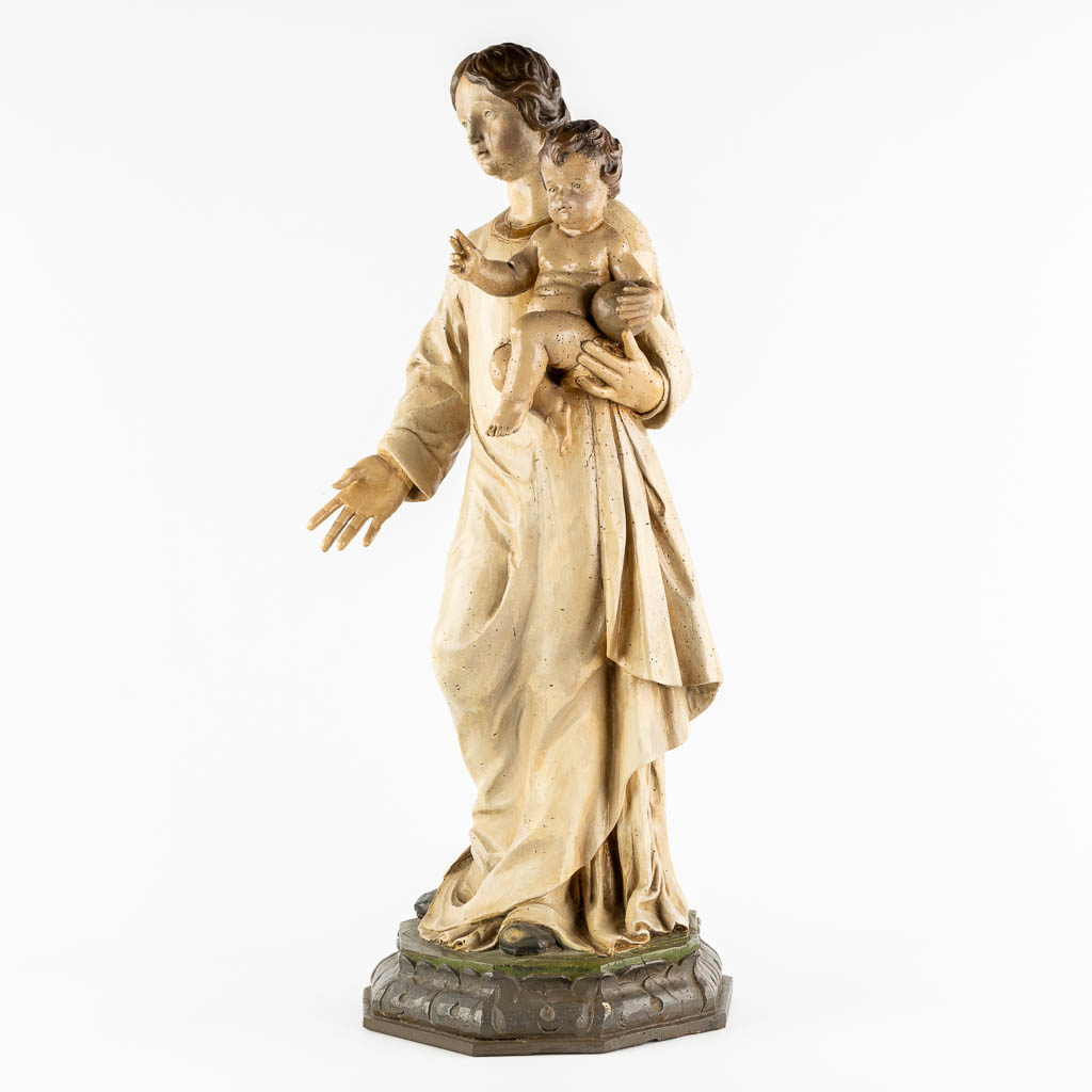 A wood-sculptured and patinated figurine of Madonna with a child. 18th C. (L:33 x W:34 x H:90 cm)