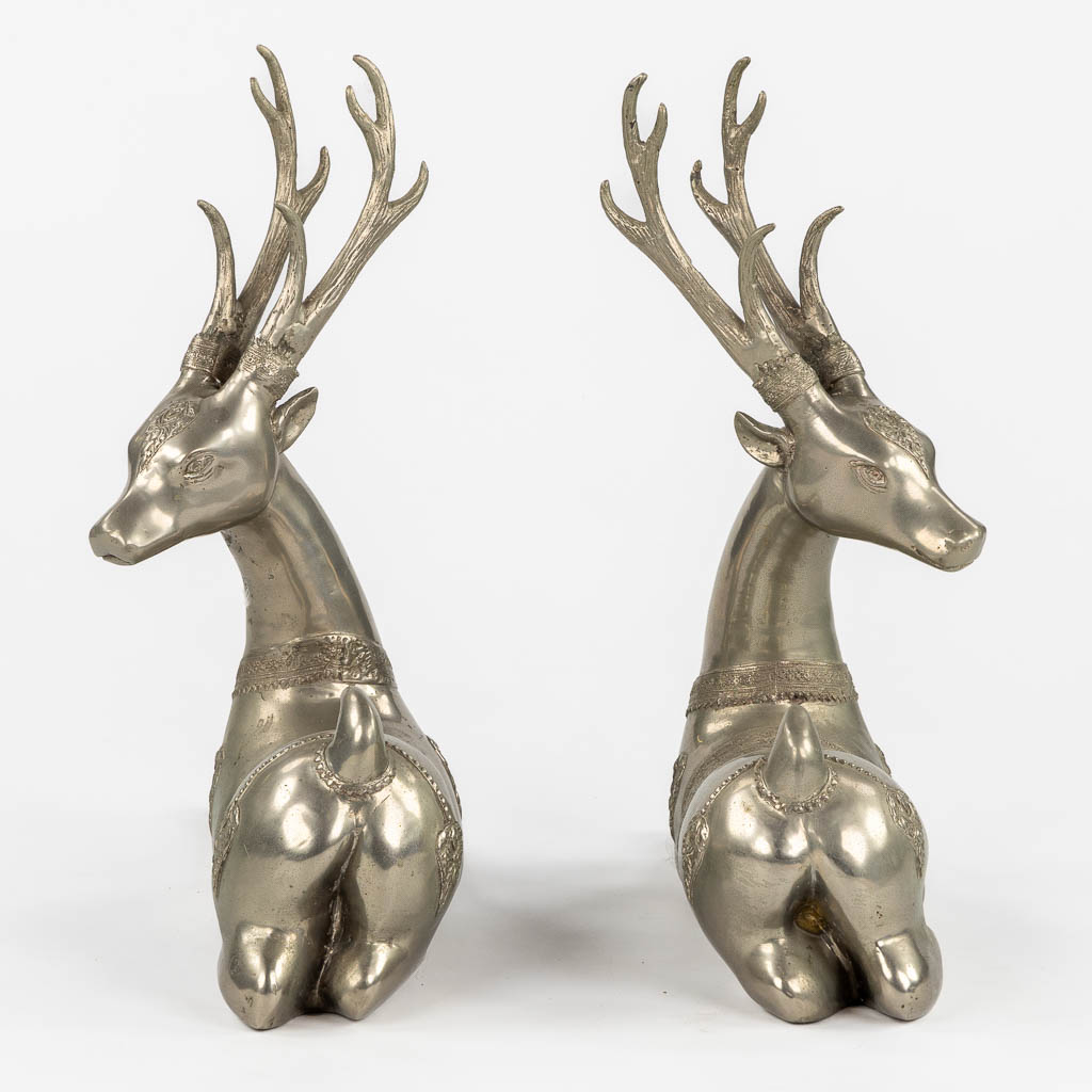 A pair of resting Temple Deer, silver-plated bronze. Circa 1970. (L:22 x W:51 x H:51 cm)