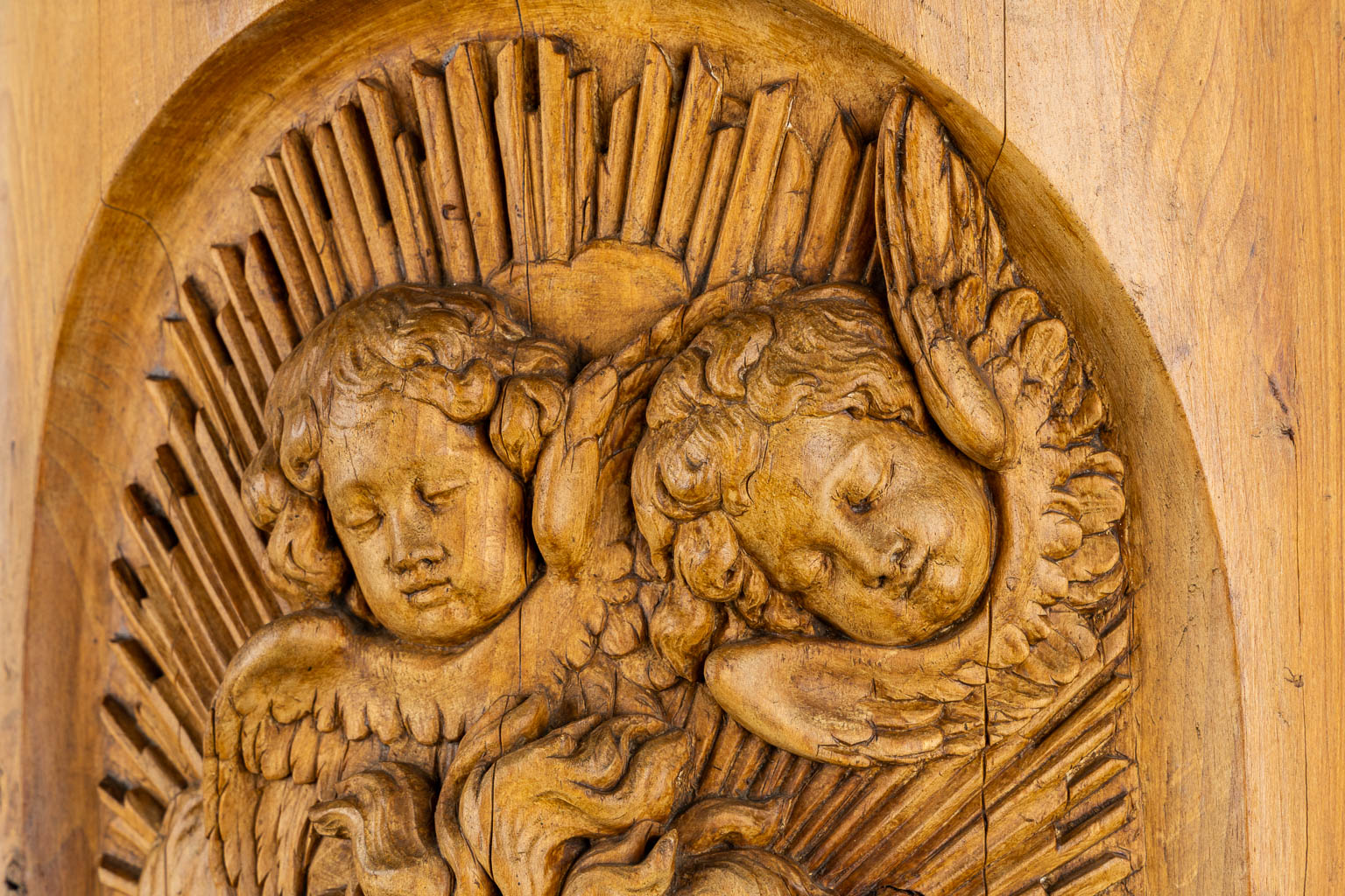 A wood-sculptured tabernacle door, Angels and a Sacred Heart, Baroque style. 