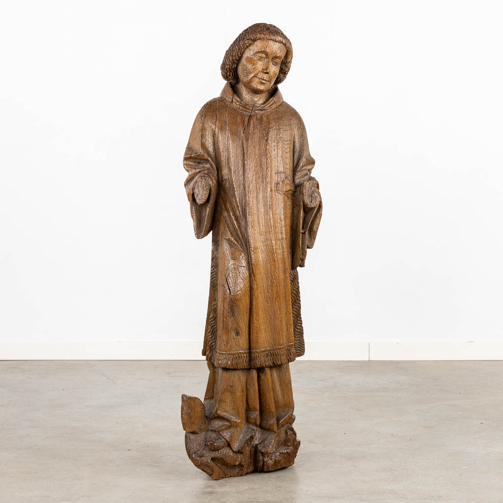 An antique, wood-sculptured figurine of Dacon Laurentius, Gothic, circa 1400. (L:22 x W:36 x H:117 cm)