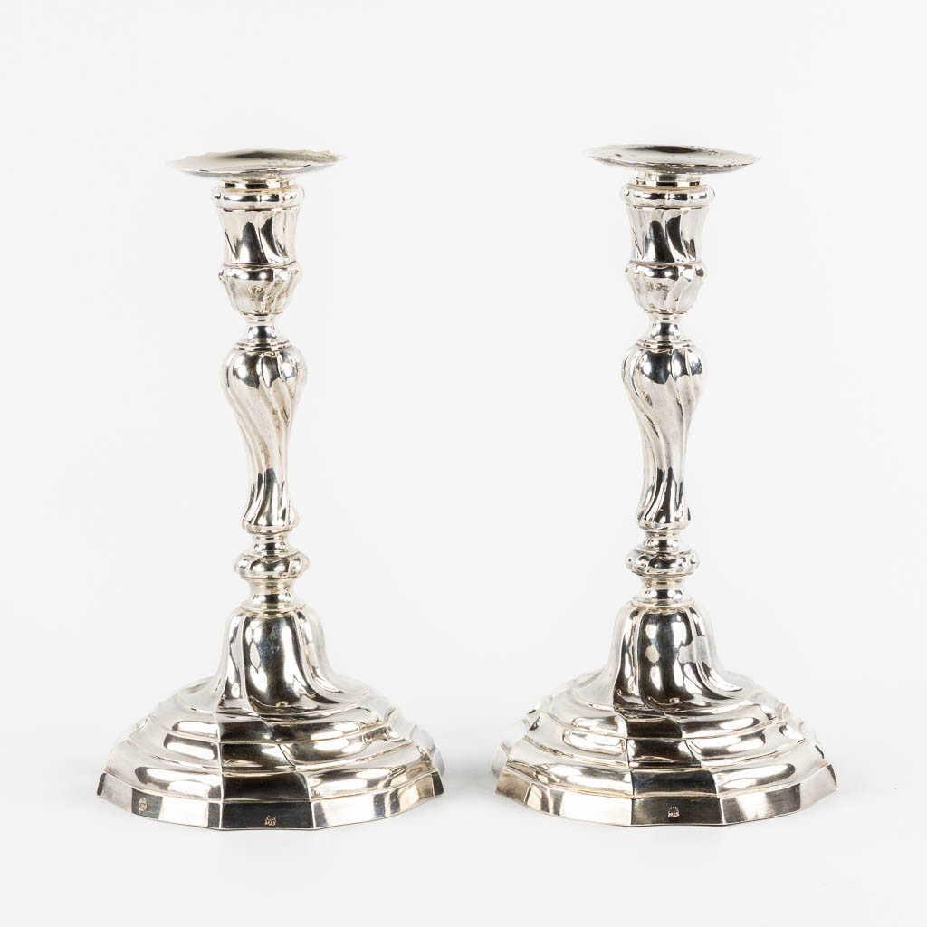 A pair of Louis XV style candlesticks, Silver, 1815-1832, after 18th C. models. 652g. 