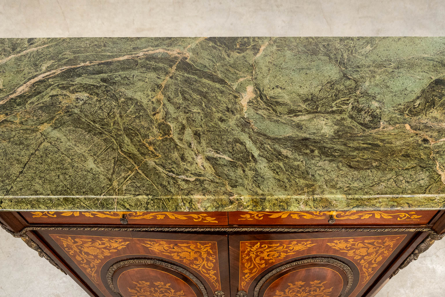 A two-door marquetry inlay cabinet, mounted with bronze and a marble. 20th C.