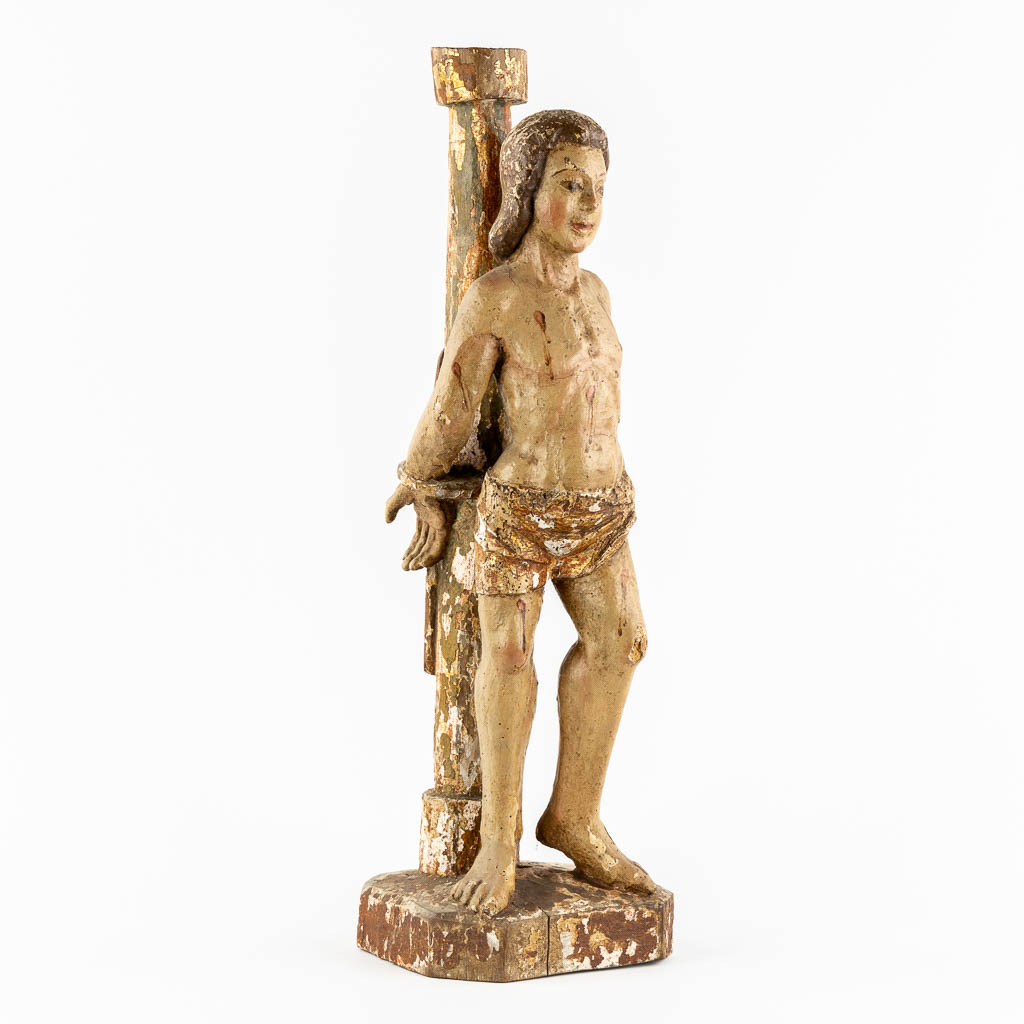 An antique wood-sculpture 'Saint Sebastian', patinated and gilt. 17th/18th C.