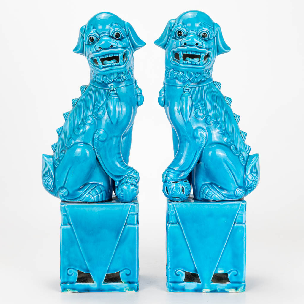 A pair of Foo dogs made of Chinese porcelain with a blue glaze. 