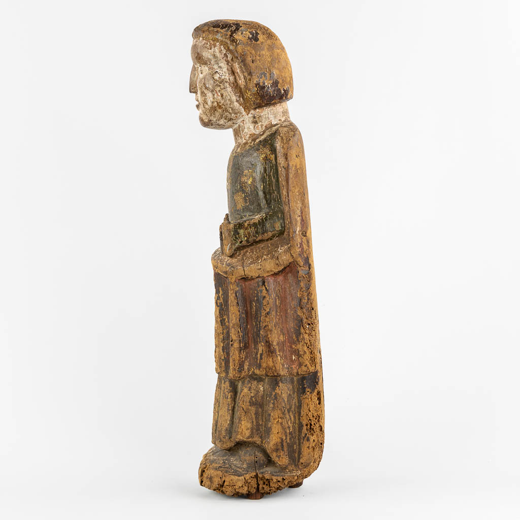 An antique wood sculpture of a Deacon, Roman period, possibly Catalonia. 12th C. (L:14 x W:15 x H:57 cm)