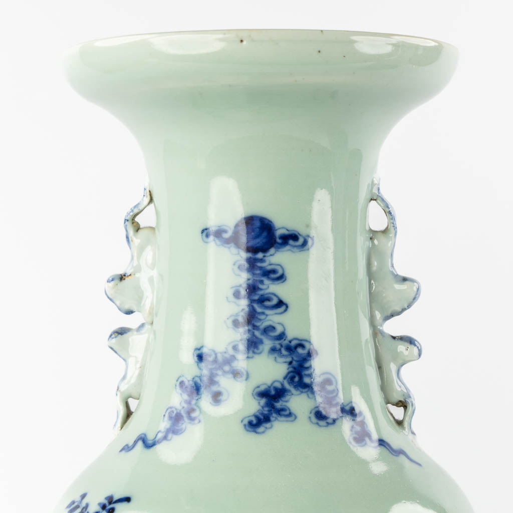 A pair of Chinese vases with a blue-white decor of playing children. (H:57,5 x D:21 cm)