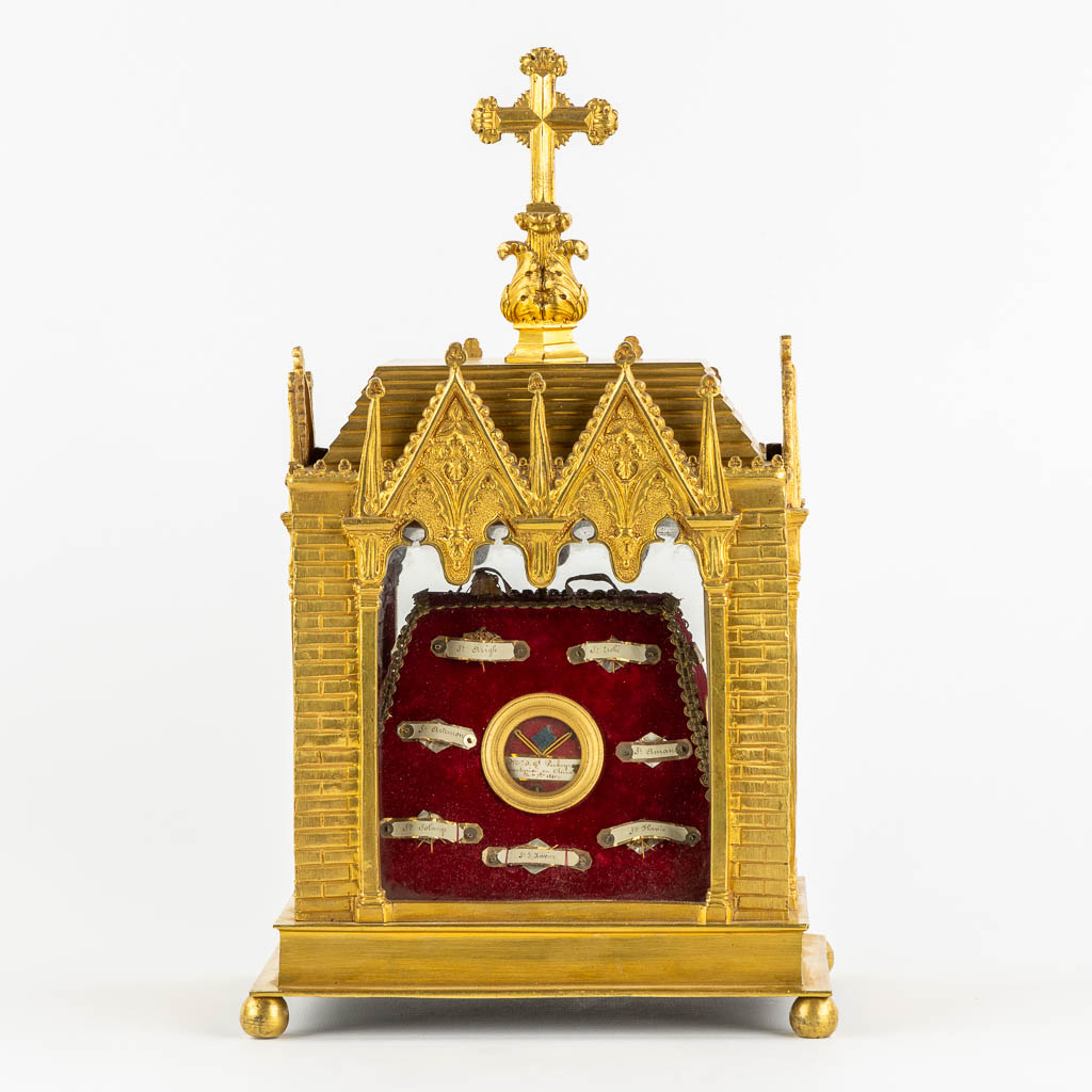 A reliquary shrine, gilt bronze with 23 relics. 19th C. (L:17 x W:22 x H:36 cm)