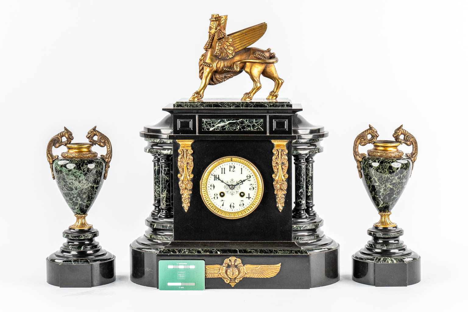 A Neoclassical three-piece mantle garniture clock and side pieces, marble and bronze. 19th C.