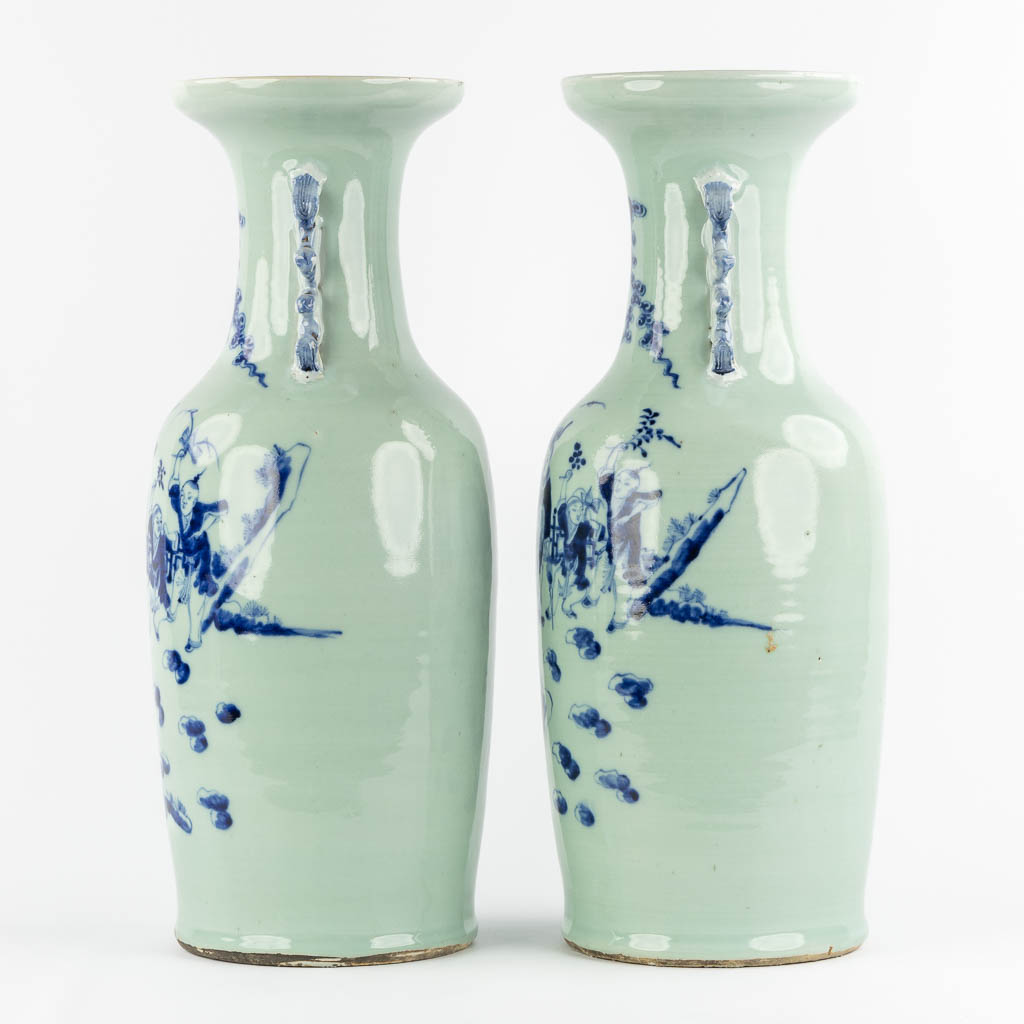 A pair of Chinese vases with a blue-white decor of playing children. (H:57,5 x D:21 cm)