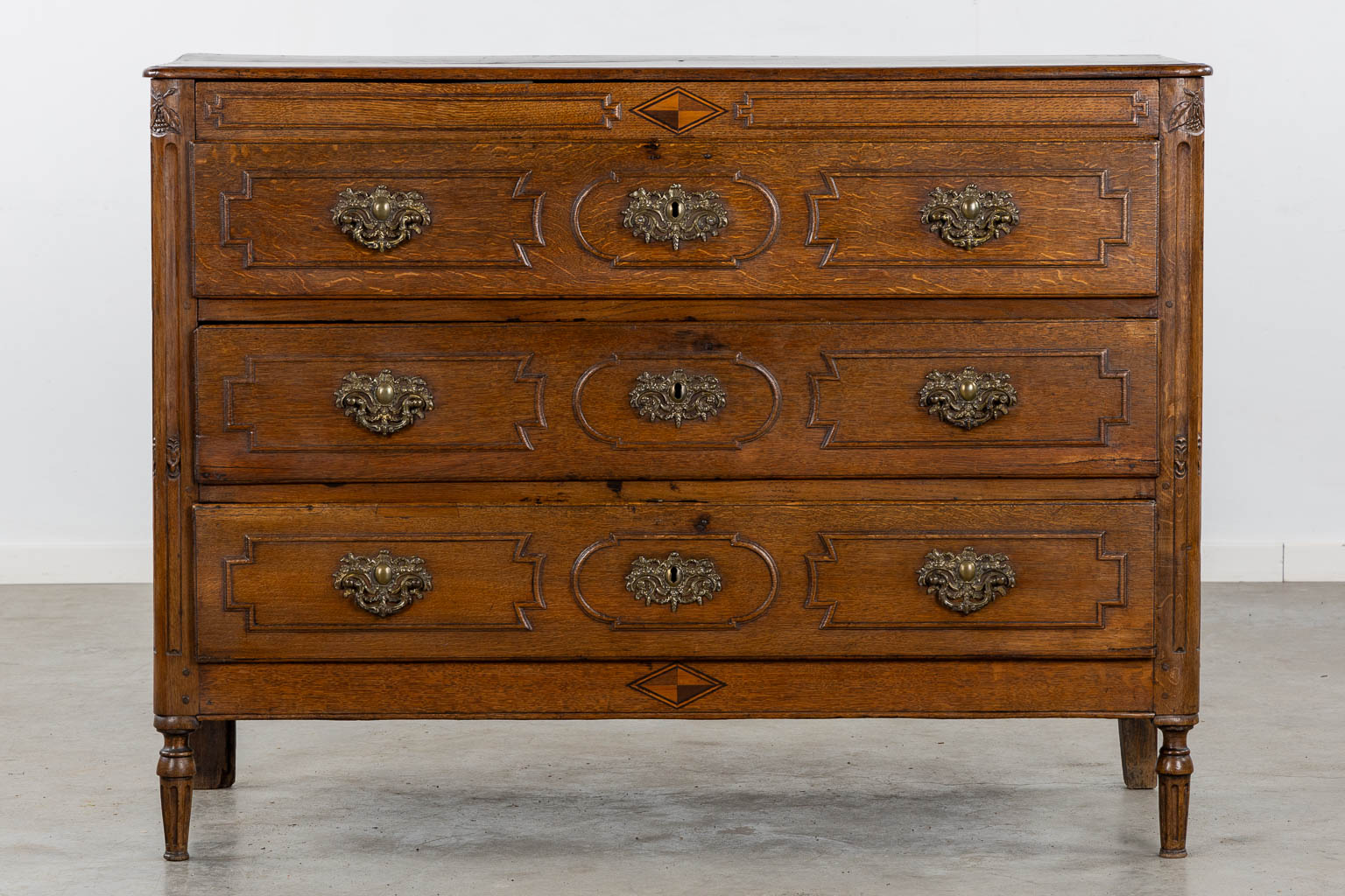 Een commode met 3 lades in Lodewijk XVI. 18de eeuw. (L:55 x W:132 x H:99 cm)