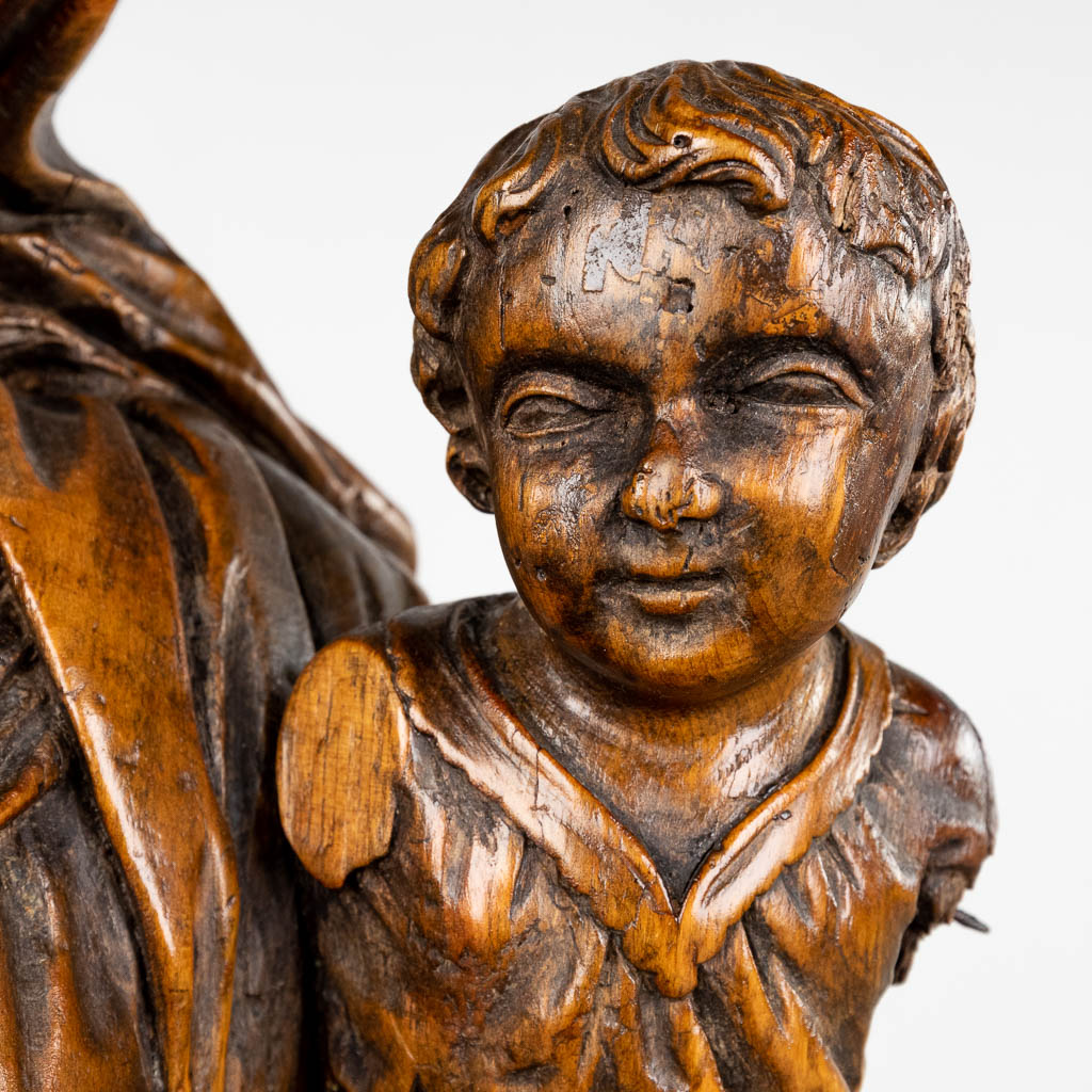 Een antieke houtsculptuur van Madonna met kind. 17de/18de eeuw (L:27 x W:44 x H:99 cm)