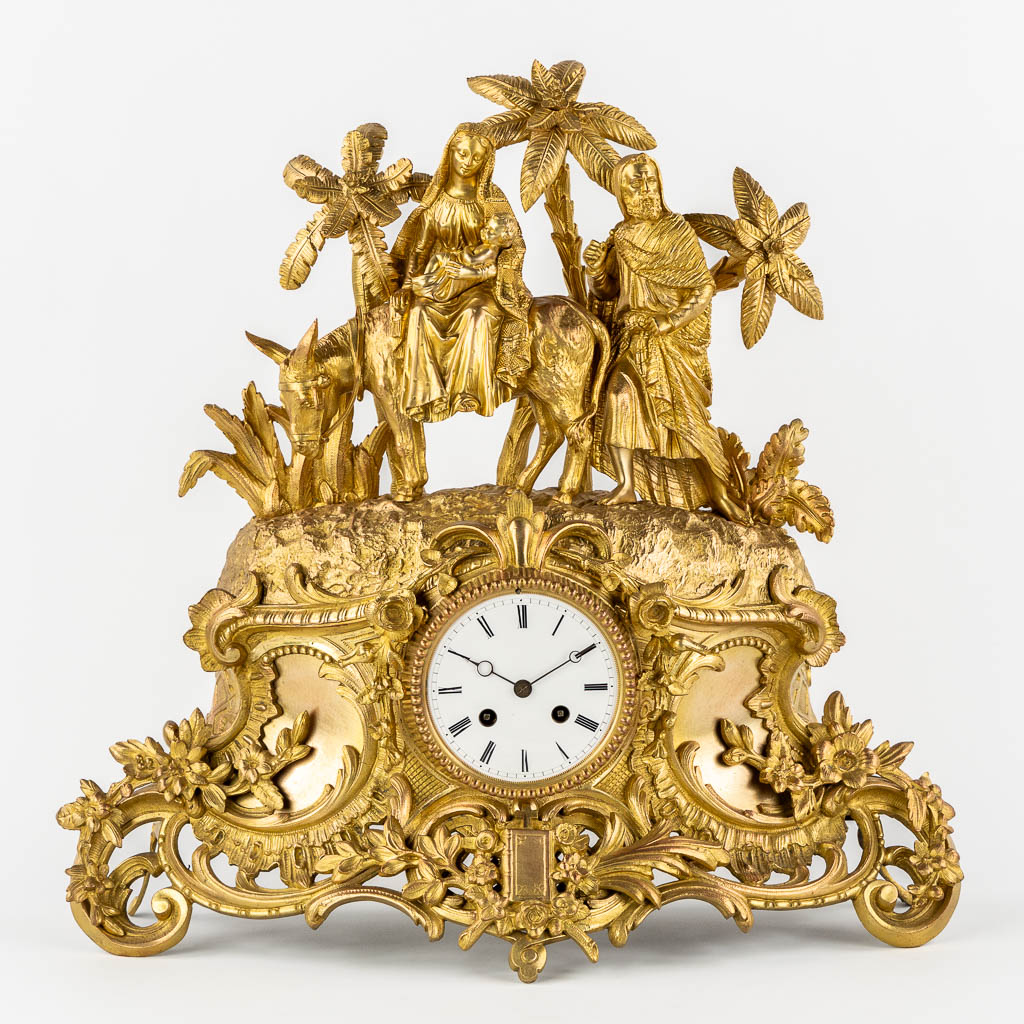 A mantle clock gilt bronze 'The Flight into Egypt'. 19th C.