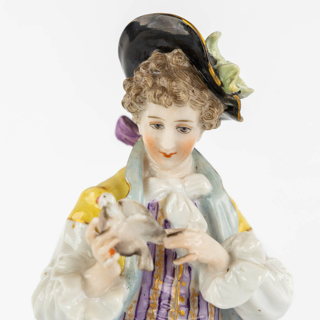 A pair of polychrome porcelain figurines, added A Saxony porcelain boy. (H:23,5 cm)