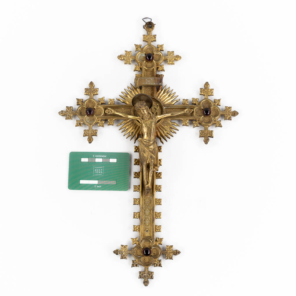 A crucifix, brass with cabochons, Gothic Revival. Circa 1900.