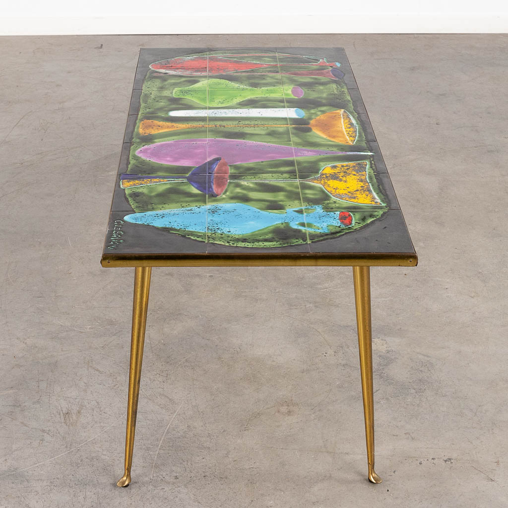 A mid-century coffee table with ceramic tile top, signed 