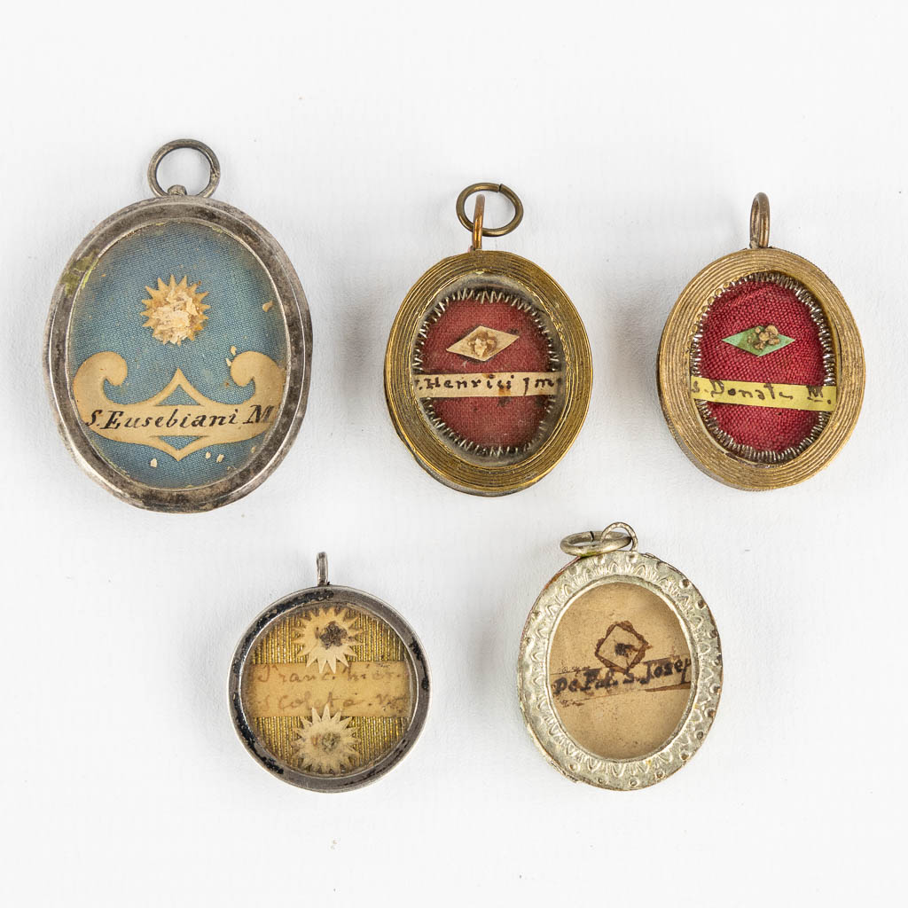 Five sealed theca pendants with relics for saints. 