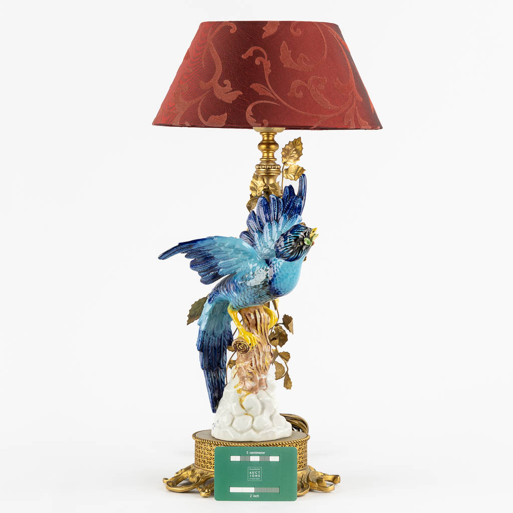 A decorative table lamp, brass mounted with polychrome porcelain. (L:16 x W:18 x H:45 cm)