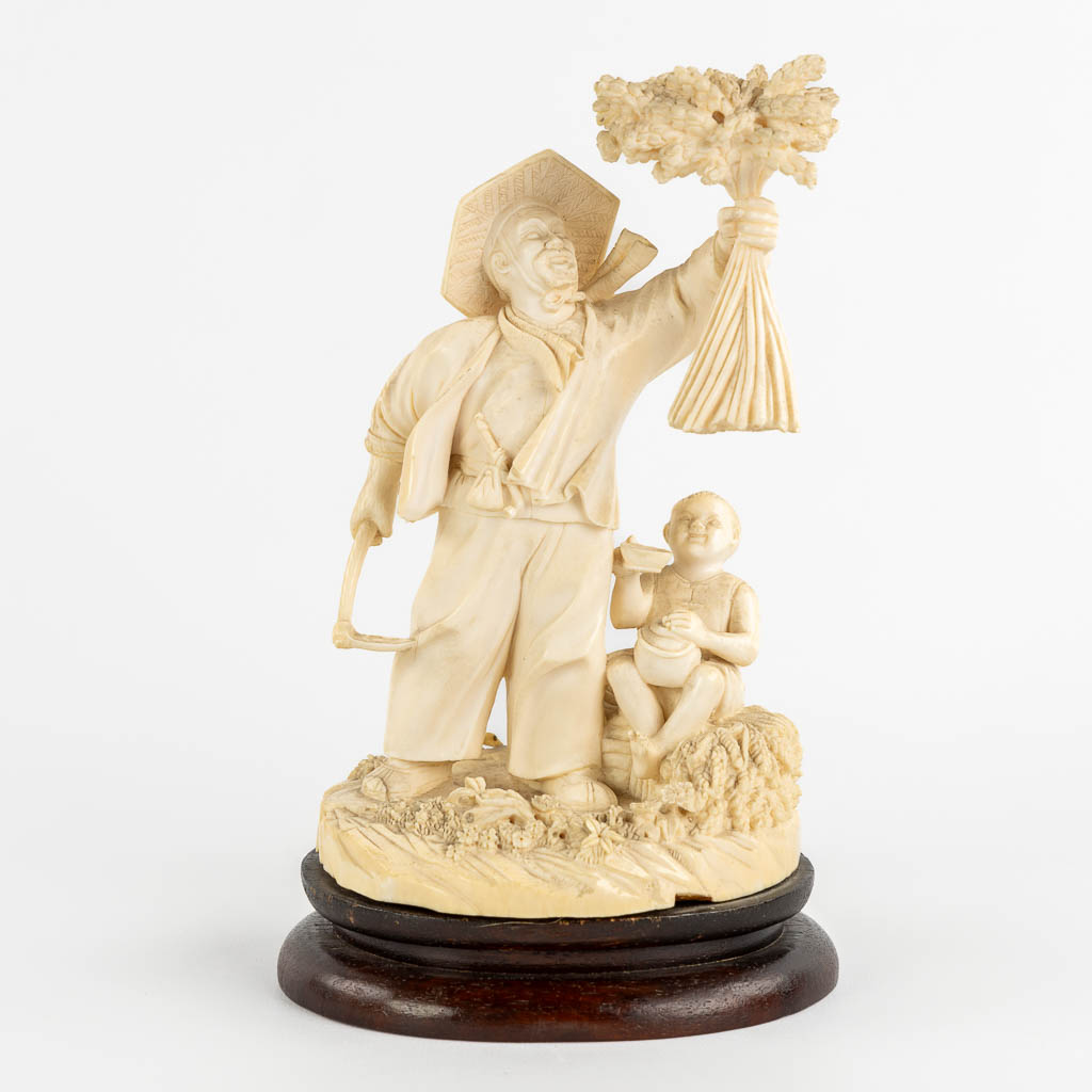 An antique Chinese ivory sculpture 'The Harvest'. Late Qing Dynasty. (L:10 x W:11 x H:19 cm)