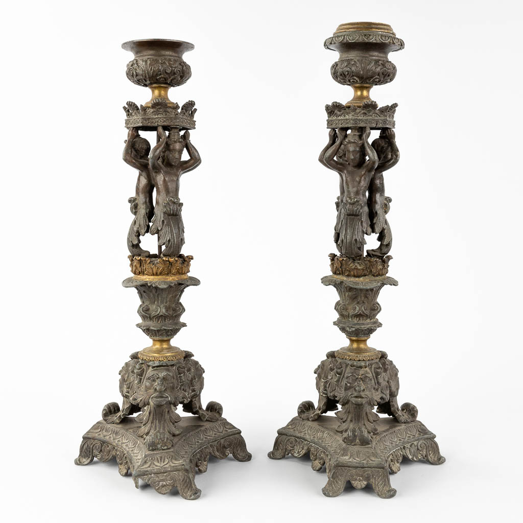 A pair of candlesticks decorated with Karyatids. Spelter and bronze. 19th C. (L:17 x W:17 x H:48 cm)