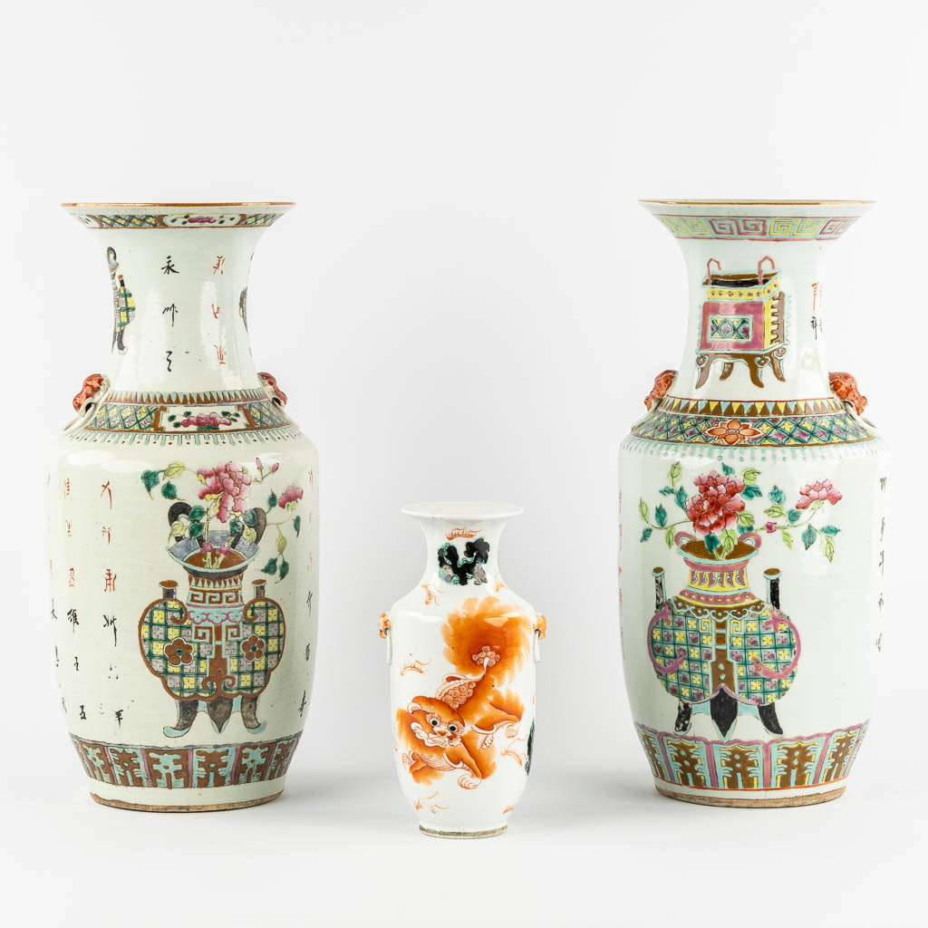 Two Chinese Famille Rose vases. Added a small vase with a Red Foo Dog. 