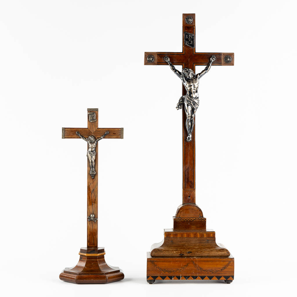 Two crucifixes with a silver Corpus Christi, 19th C. (W:24 x H:70 cm)