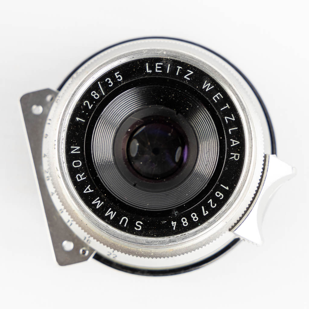 Leica, Four lenses and two filters. (H:15,5 cm)