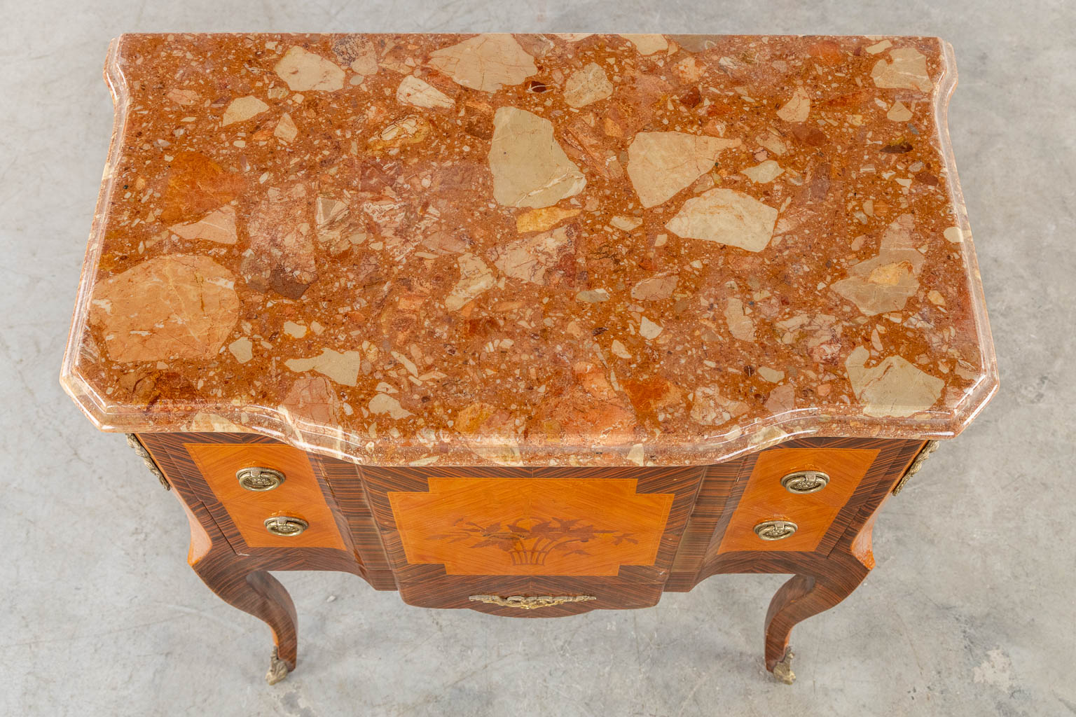 A two drawer side cabinet, marquetry inlay with a marble top. (L:39 x W:72 x H:81 cm)