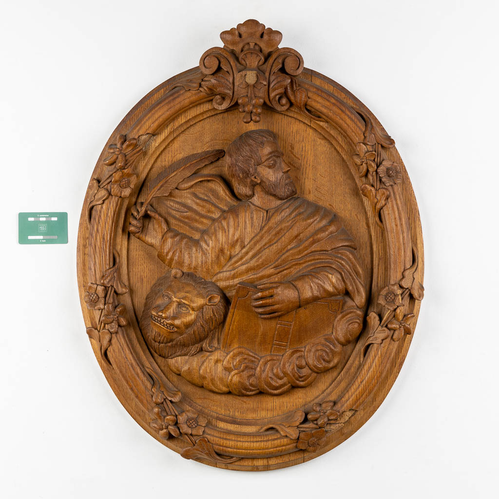 A set of four big oval wood sculptures depicitng 