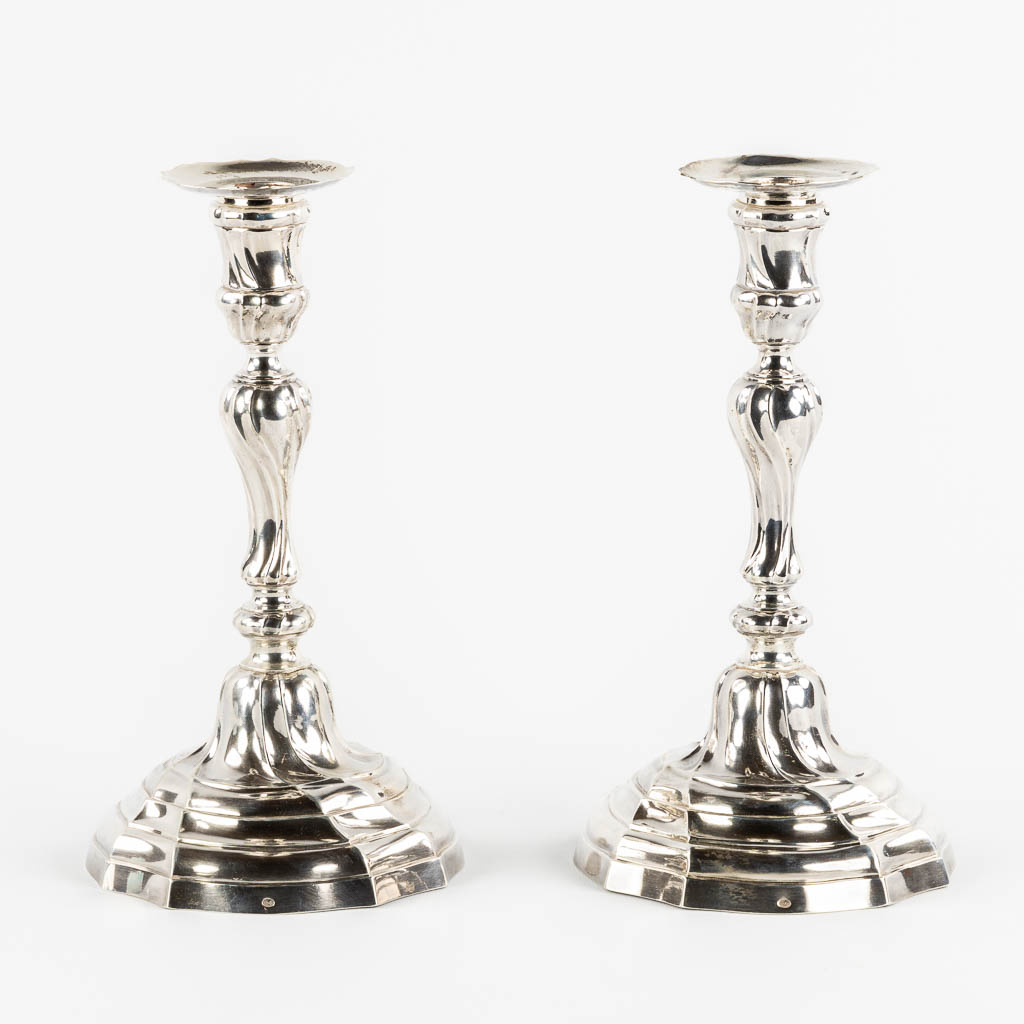 A pair of Louis XV style candlesticks, Silver, 1815-1832, after 18th C. models. 652g. 