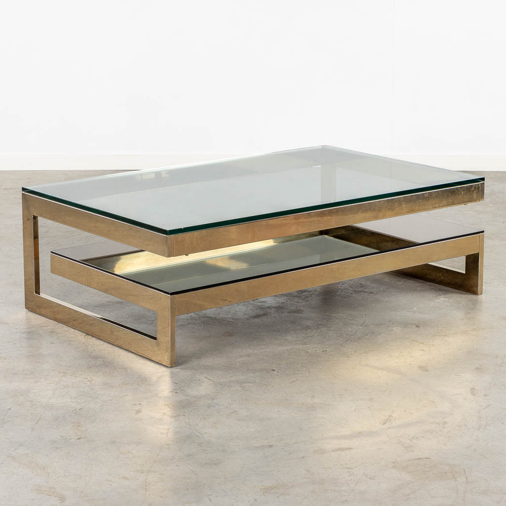 Belgo Chrome, een G-shape salontafel. Verguld metaal en glas. (L:120 x W:75 x H:38 cm)