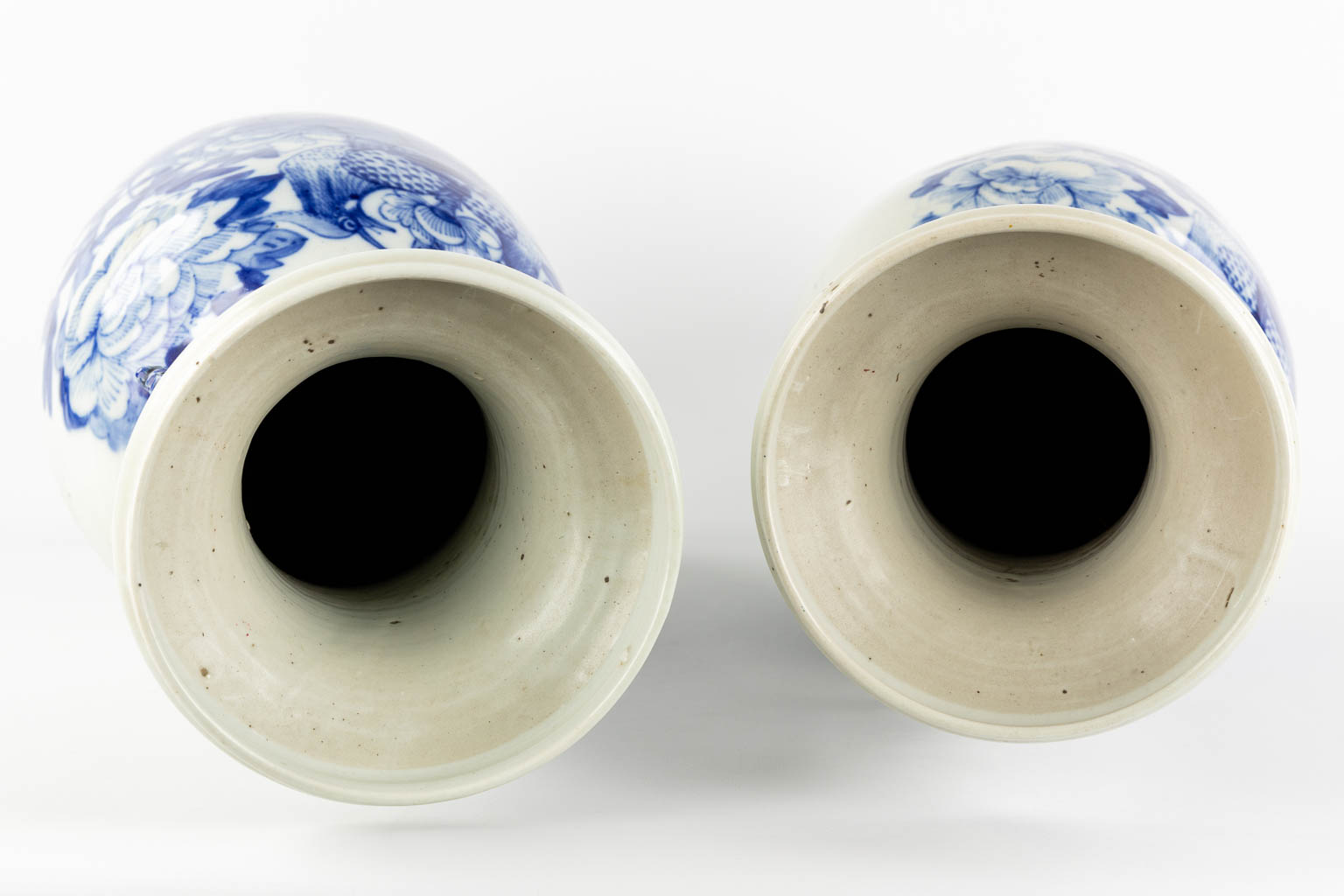 A pair of Chinese Celadon ground vases with a blue floral decor. (H:57 x D:22 cm)