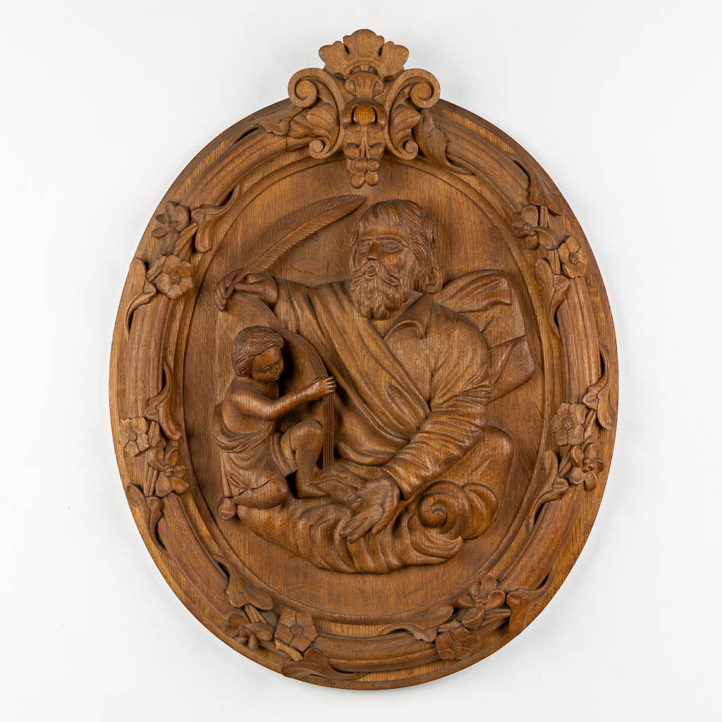 A set of four big oval wood sculptures depicitng 