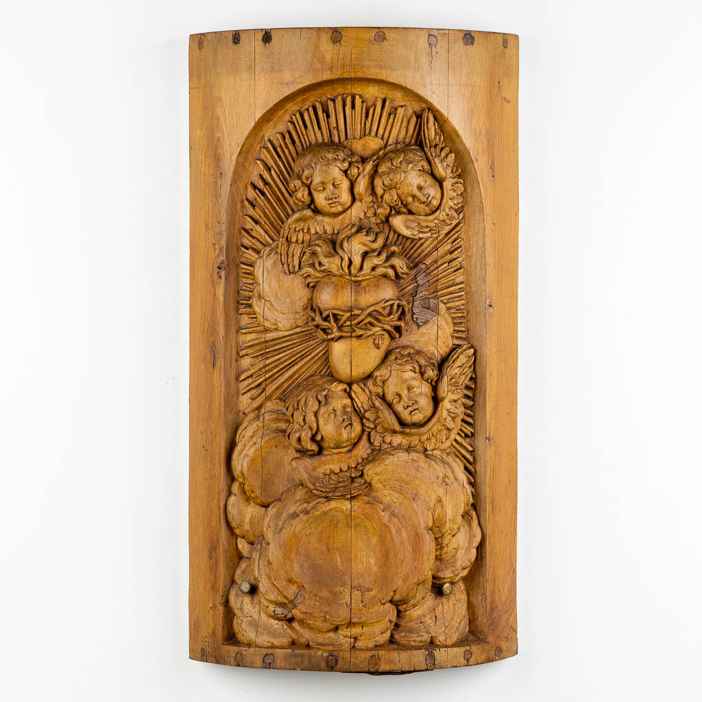 A wood-sculptured tabernacle door, Angels and a Sacred Heart, Baroque style. 