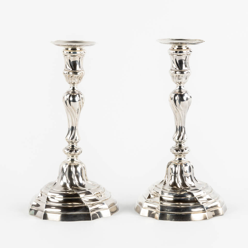 A pair of Louis XV style candlesticks, Silver, 1815-1832, after 18th C. models. 652g. 