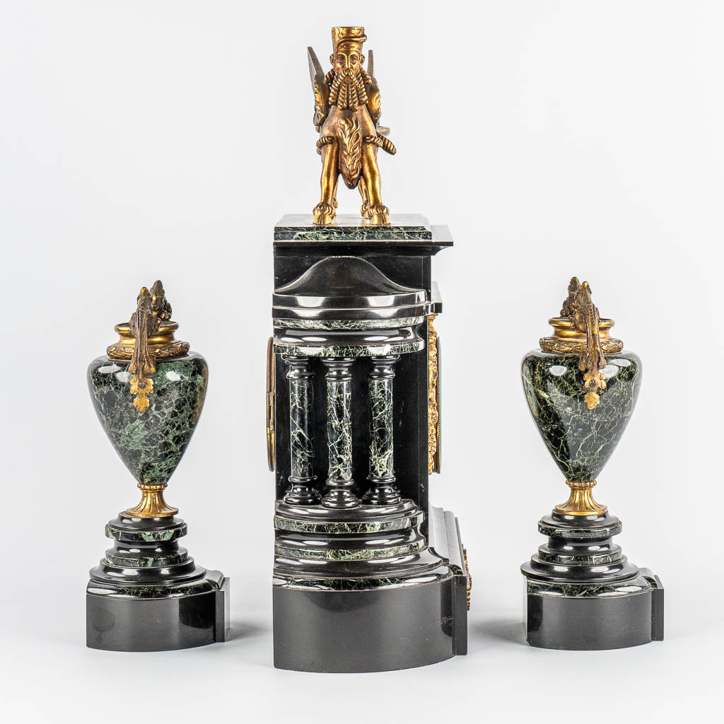 A Neoclassical three-piece mantle garniture clock and side pieces, marble and bronze. 19th C.