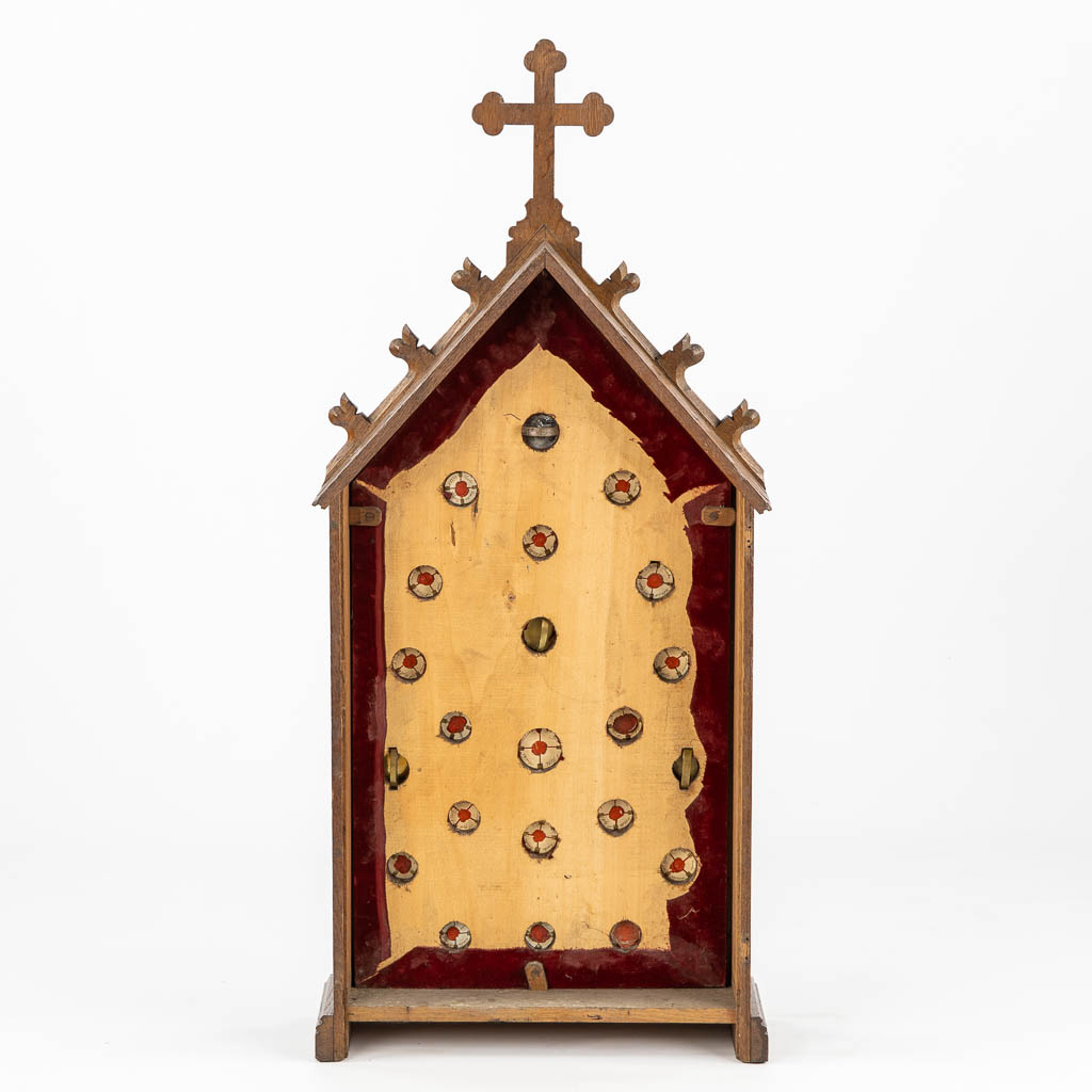 A wood-sculptured reliquary case with 22 sealed theca, including the True Cross of Jesus Christ. 19th C. (L:18 x W:48 x H:108 cm