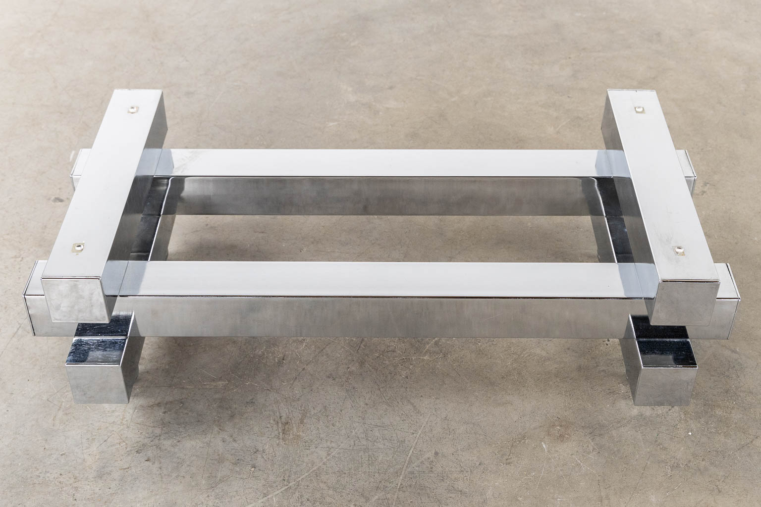 A coffee table, chromed steel and glass. (L:52 x W:104 x H:31 cm)