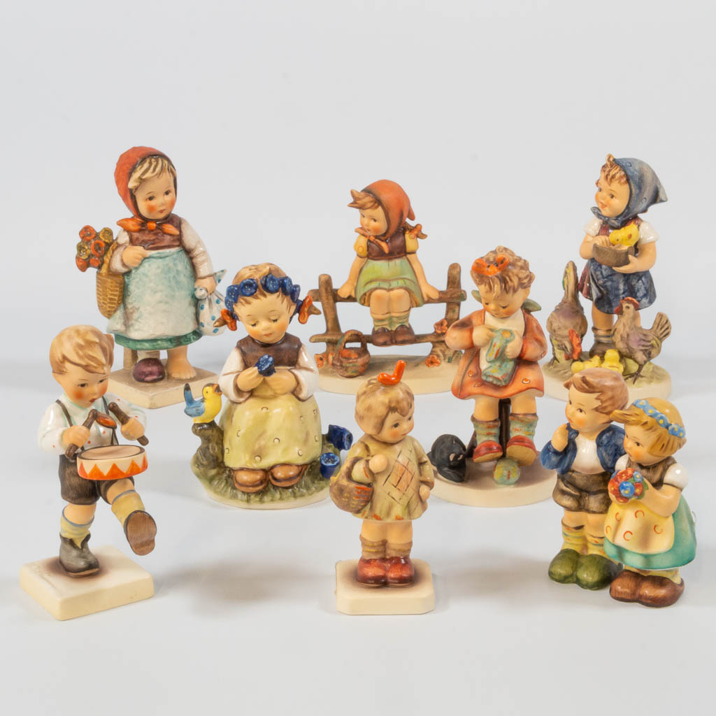 A collection of 8 Hummel statues. 