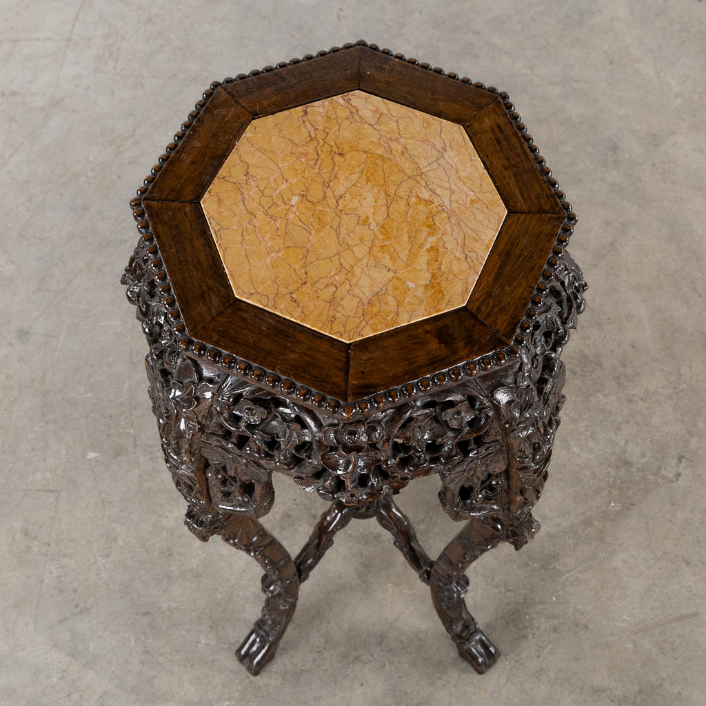 A high Oriental pedestal, sculptured hardwood with marble. (L:50 x W:50 x H:90 cm)