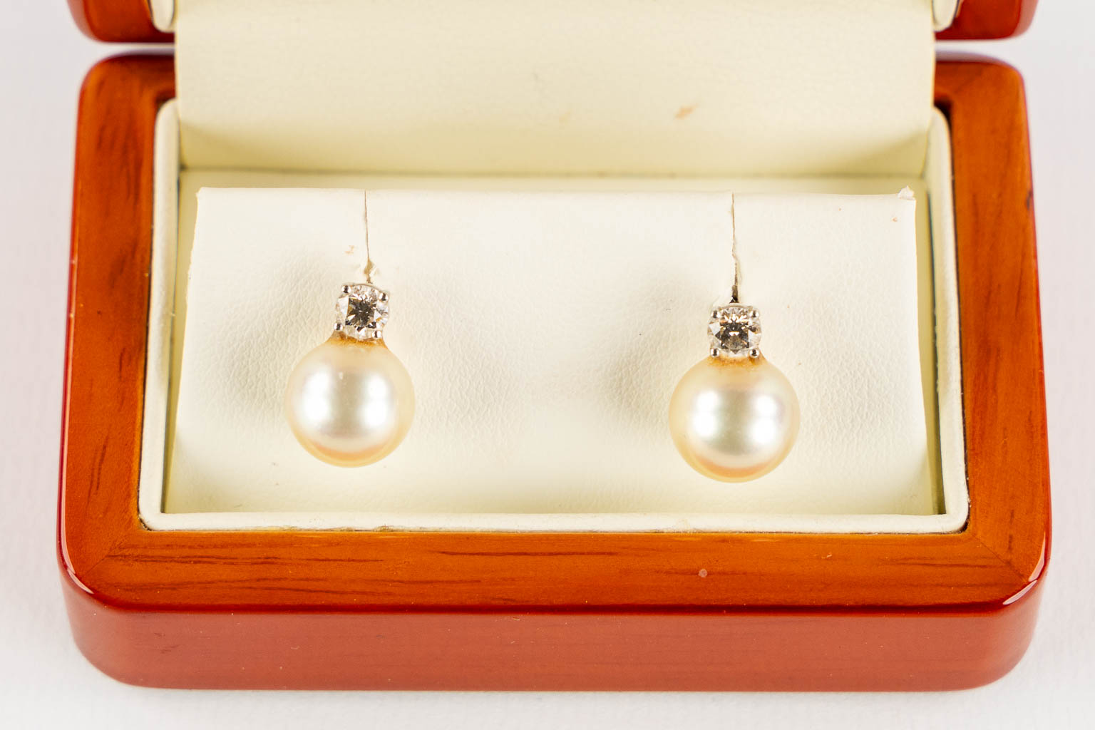 A pair of earrings, 18kt white gold with a brillant and a Myanmar South Sea pearls. 