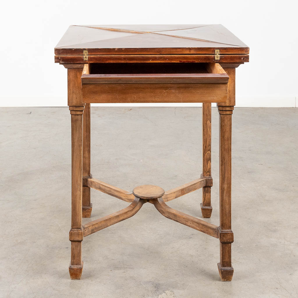 An antique game table with folding top. 19th C. (L:84 x W:84 x H:77 cm)