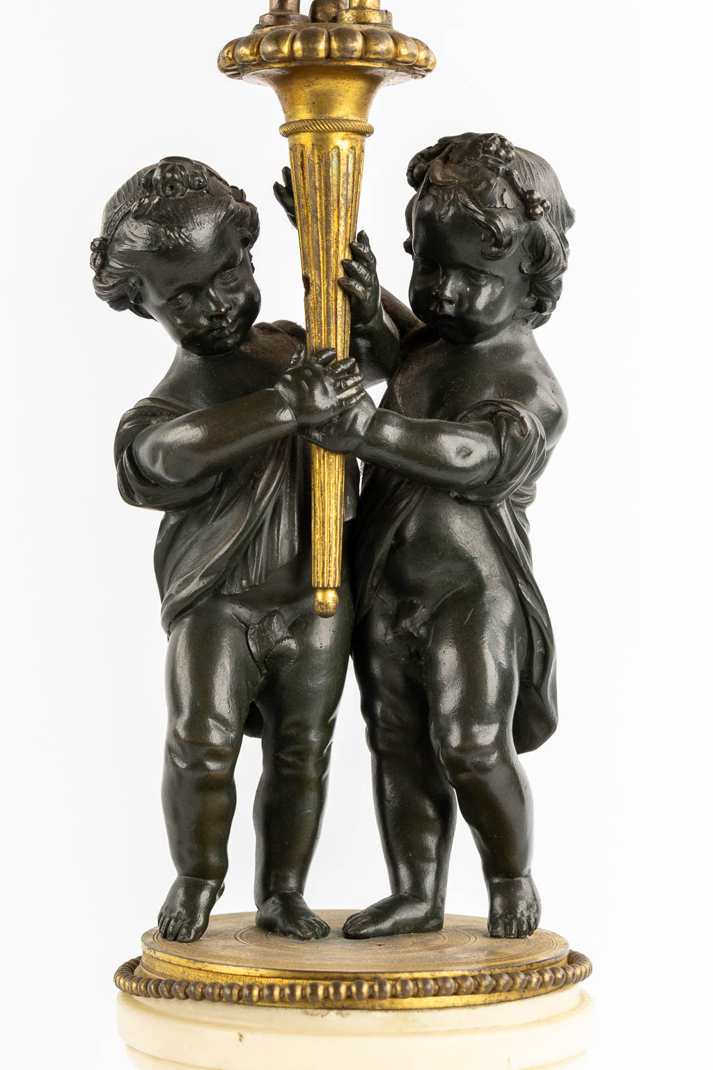 A pair of Marble, gilt and patinated bronze candelabra with putti, Louis XVI style, 19th C. (L:16,5 x W:16,5 x H:71,5 cm)