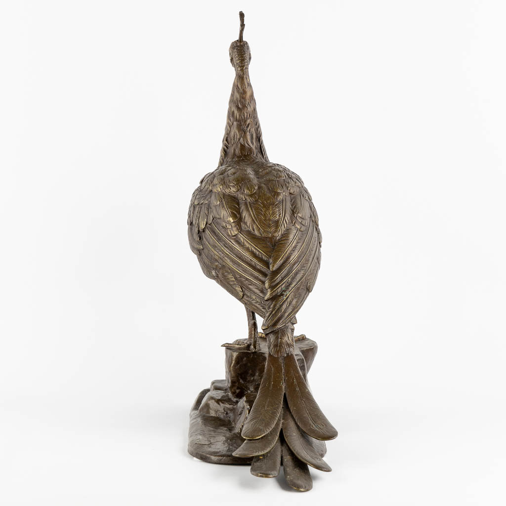 L. MAUPERTUIS (XX) A decorative figurine of a Peacock, patinated bronze. (L:17 x W:57 x H:50 cm)