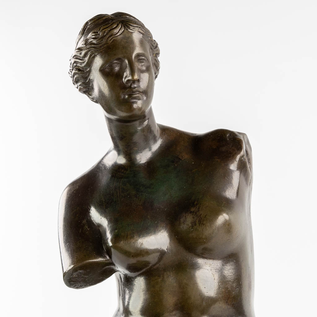 Venus van Milo, patinated bronze on a marble base. (L:18 x W:23 x H:75 cm)